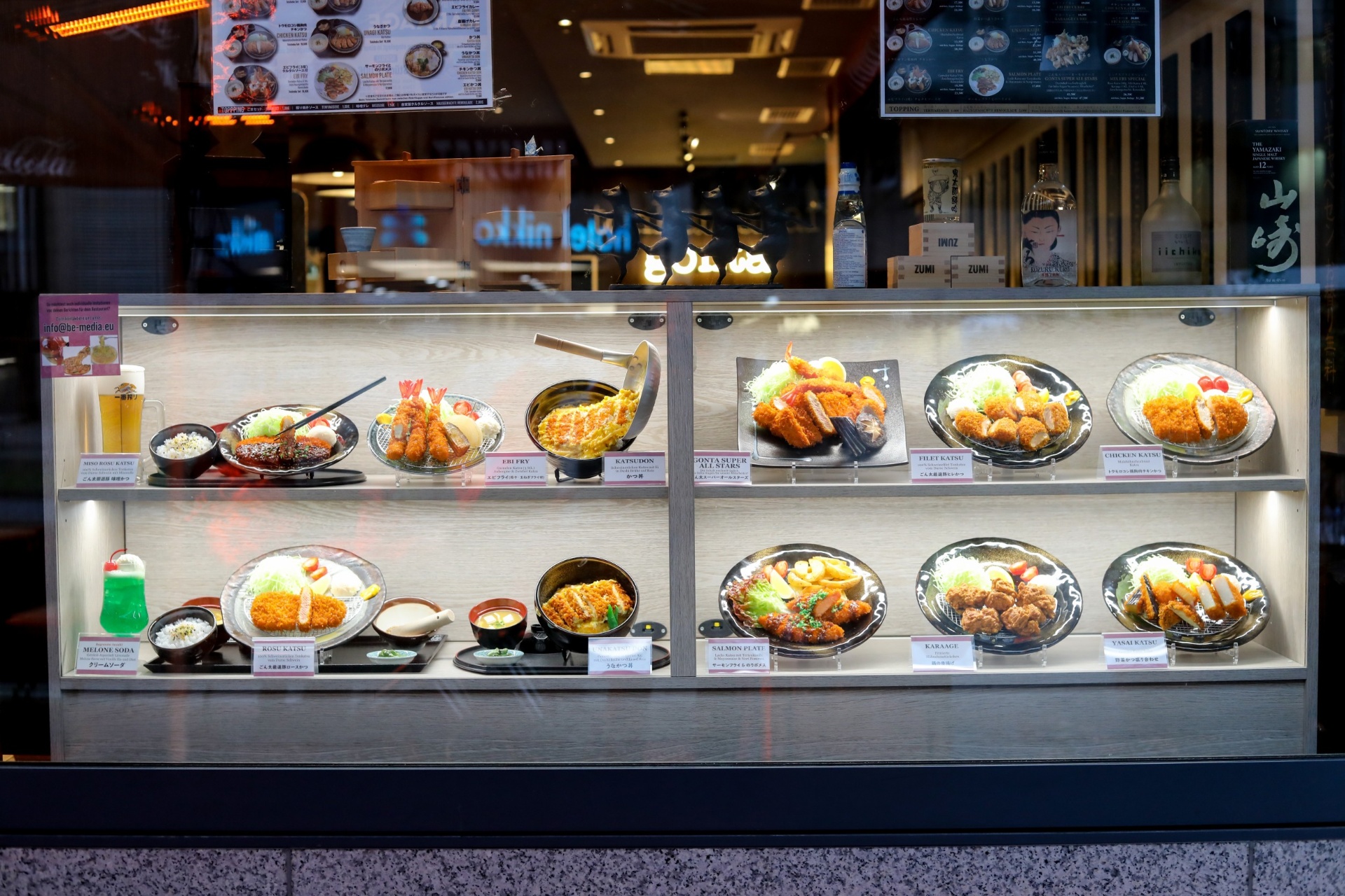 Custom katsu window display case food replica, lit at dusk.