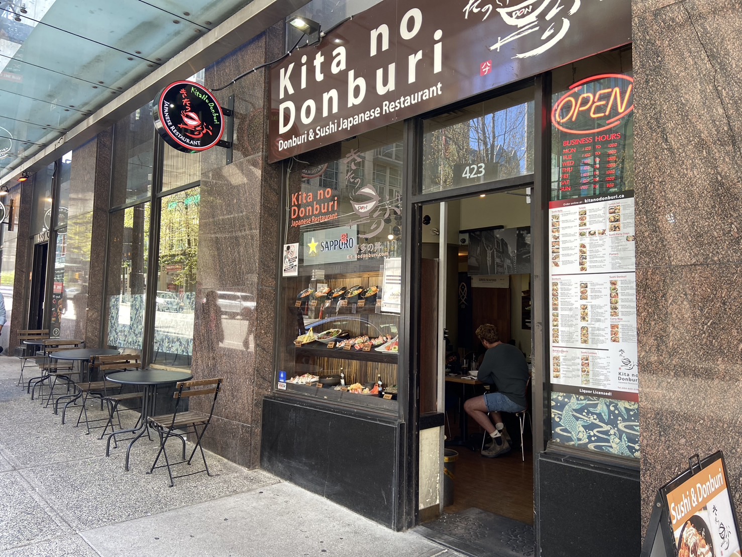 Restaurant storefront window with a full replica menu display.